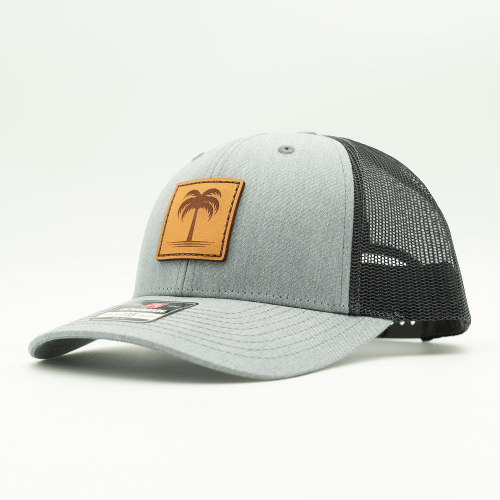 Side view of the Solo Palm Leather Patch Hat by Outer Wings in Heather Grey/Charcoal, highlighting the breathable mesh back, adjustable SnapBack, and structured profile. A durable and stylish custom leather patch hat for all-day wear.