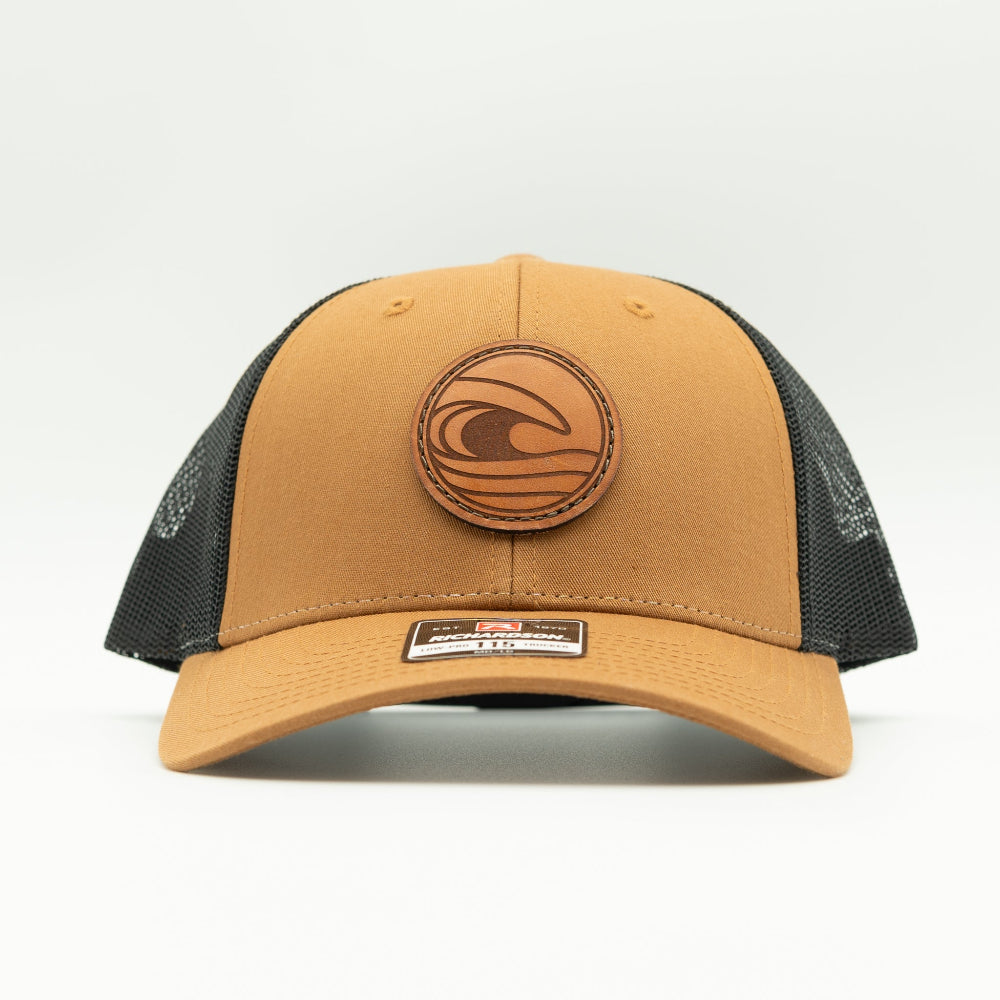 Front view of the Tidal Wave Leather Patch Hat by Outer Wings in Caramel/Black, showcasing the structured fit, breathable mesh back, and adjustable SnapBack closure. A versatile outdoors hat for outdoor enthusiasts.