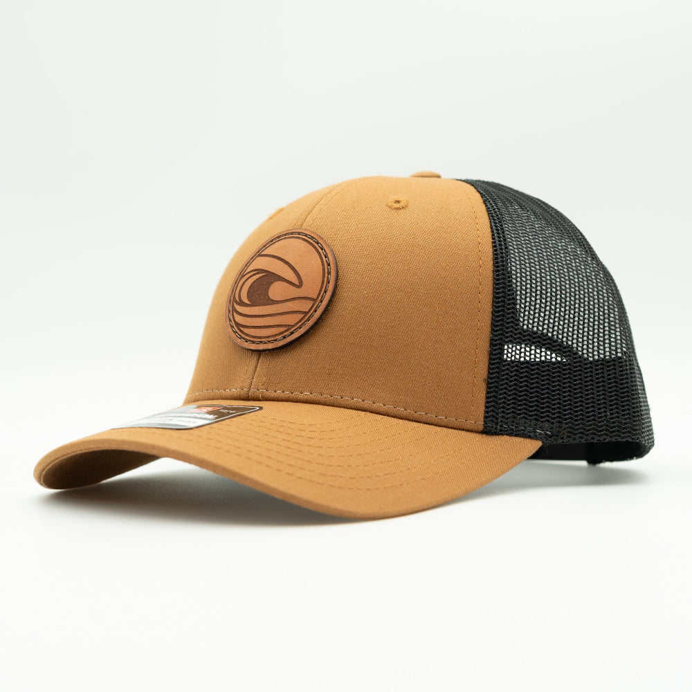 Side view of the Tidal Wave Leather Patch Hat by Outer Wings in Caramel/Black, showcasing the structured fit, breathable mesh back, and adjustable SnapBack closure. A versatile outdoors hat for outdoor enthusiasts.