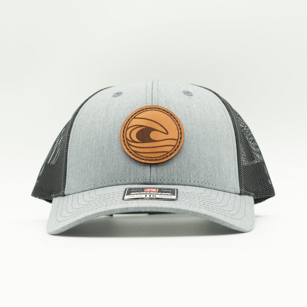 Front view of the Tidal Wave Leather Patch Hat by Outer Wings in Heather Grey/Charcoal, highlighting the structured design, mesh back, and adjustable SnapBack closure. A rugged yet stylish outdoors hat for all your adventures.