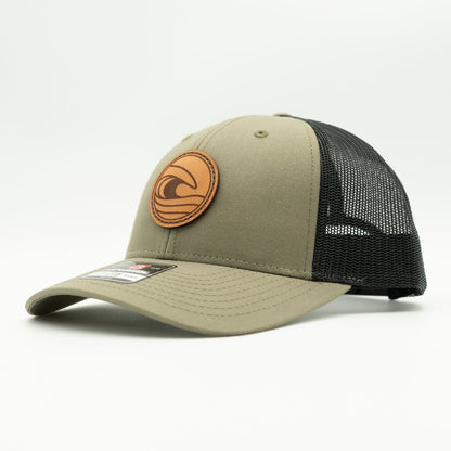 Side view of the Tidal Wave Leather Patch Hat by Outer Wings in Loden/Black, highlighting the breathable mesh back, structured profile, and adjustable SnapBack closure. A stylish custom leather patch hat for outdoor and casual wear.