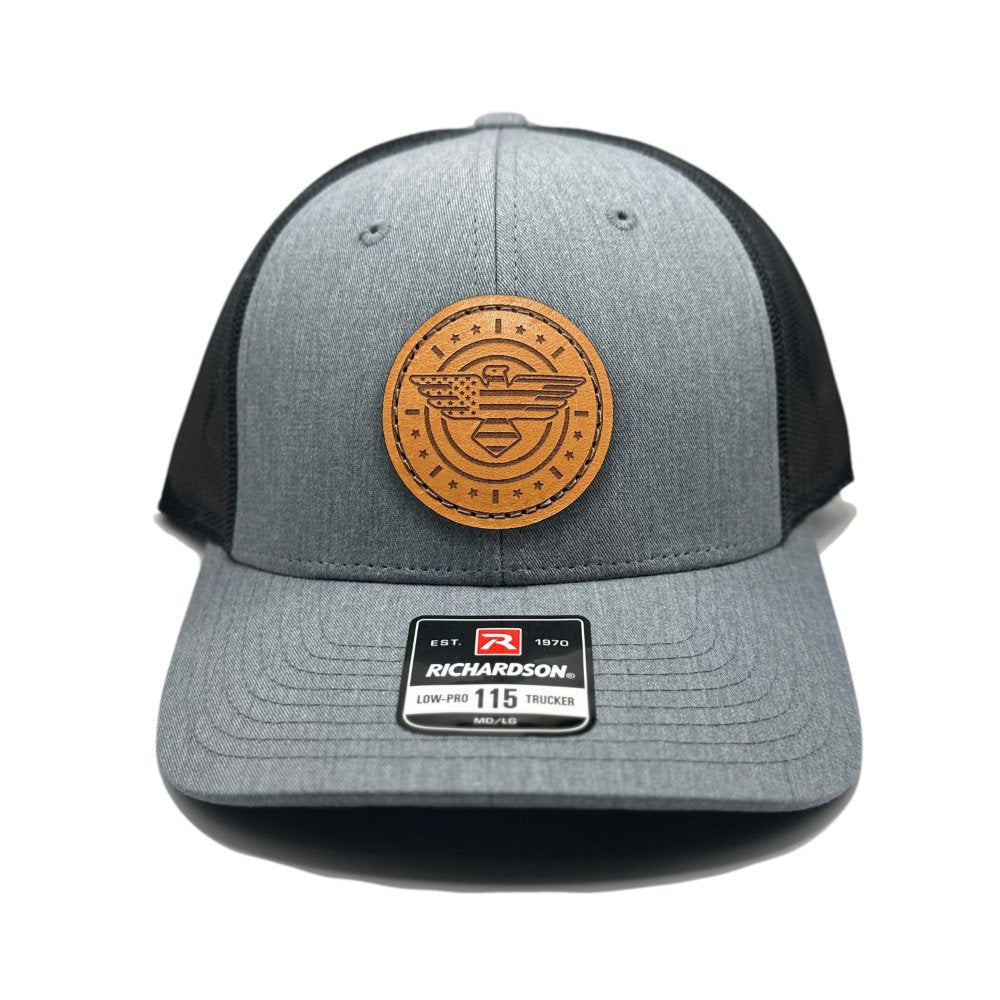 Front view of the American Eagle Design leather patch hat by Outer Wings in heather grey/dark charcoal, featuring a low-profile Richardson 115 hat with an intricate leather patch of an eagle, American flag, stars, and stripes. The heather grey front combined with dark charcoal adds a sleek and modern touch.