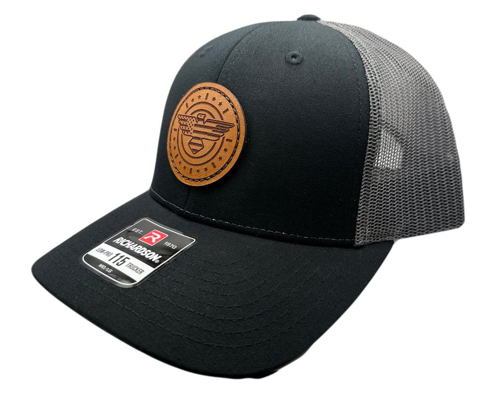 Side view of the American Eagle Design leather patch hat by Outer Wings in black/charcoal, showcasing the hat's low-profile fit and adjustable SnapBack. The detailed leather patch, featuring an eagle with flag elements, is sewn for durability and adds a unique touch to this versatile hat.