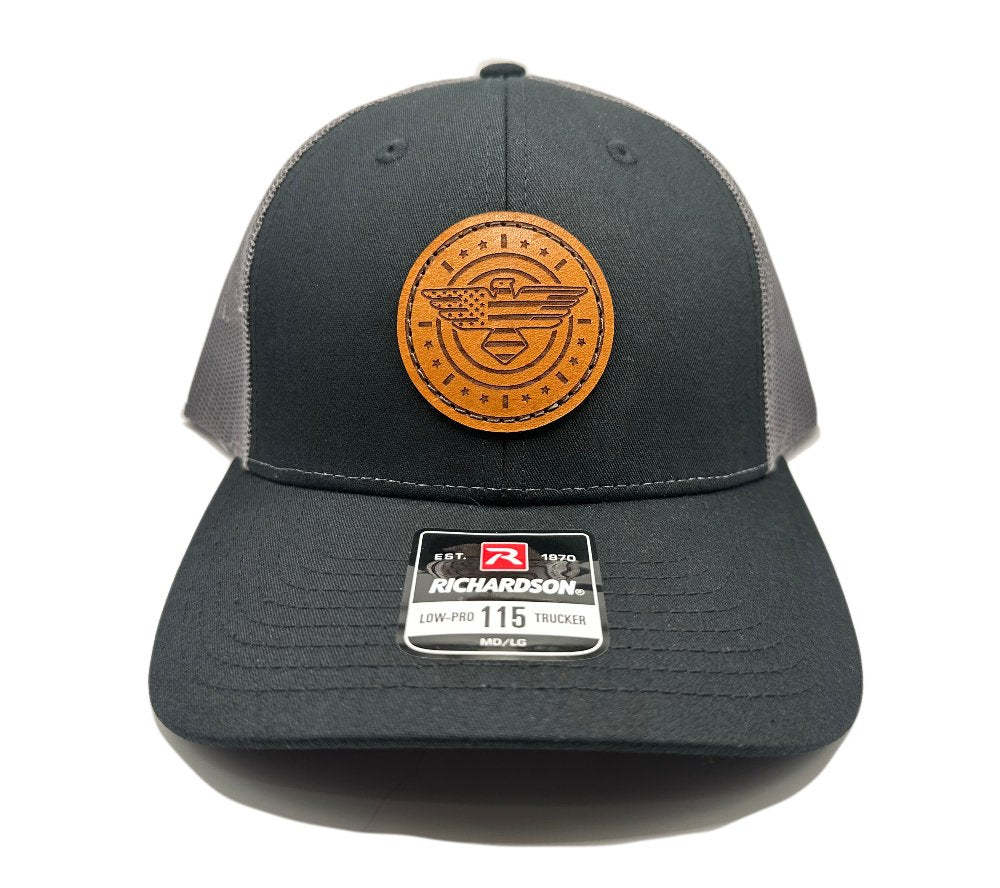 Front view of the American Eagle Design leather patch hat by Outer Wings in black/charcoal, featuring a low-profile Richardson 115 hat with a striking leather patch of an eagle, American flag, stars, and stripes. The combination of black and charcoal adds a subtle contrast, enhancing the hat’s patriotic theme.