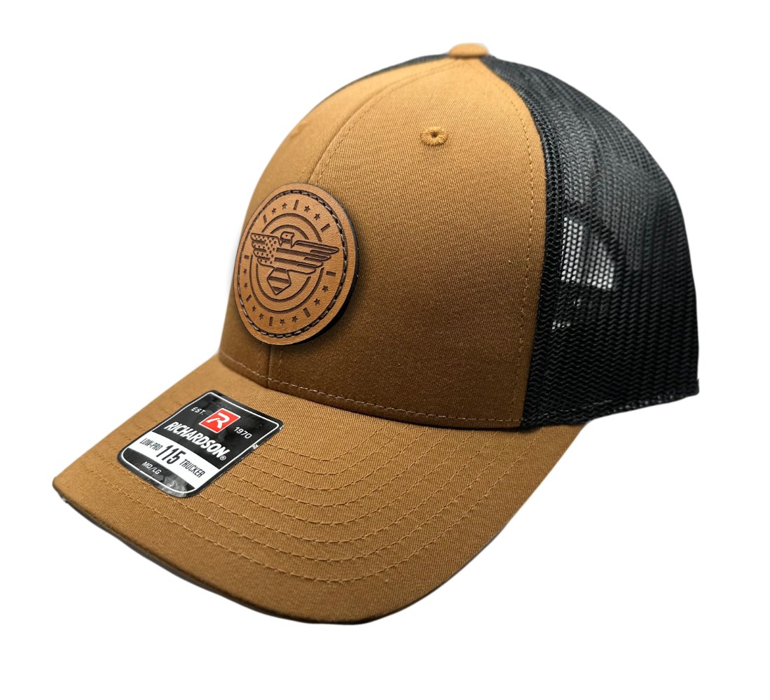 Side view of the American Eagle Design leather patch hat by Outer Wings in caramel/black, showcasing the hat’s low-profile design, adjustable SnapBack, and a striking leather patch featuring an eagle and flag elements, sewn for added durability and style.