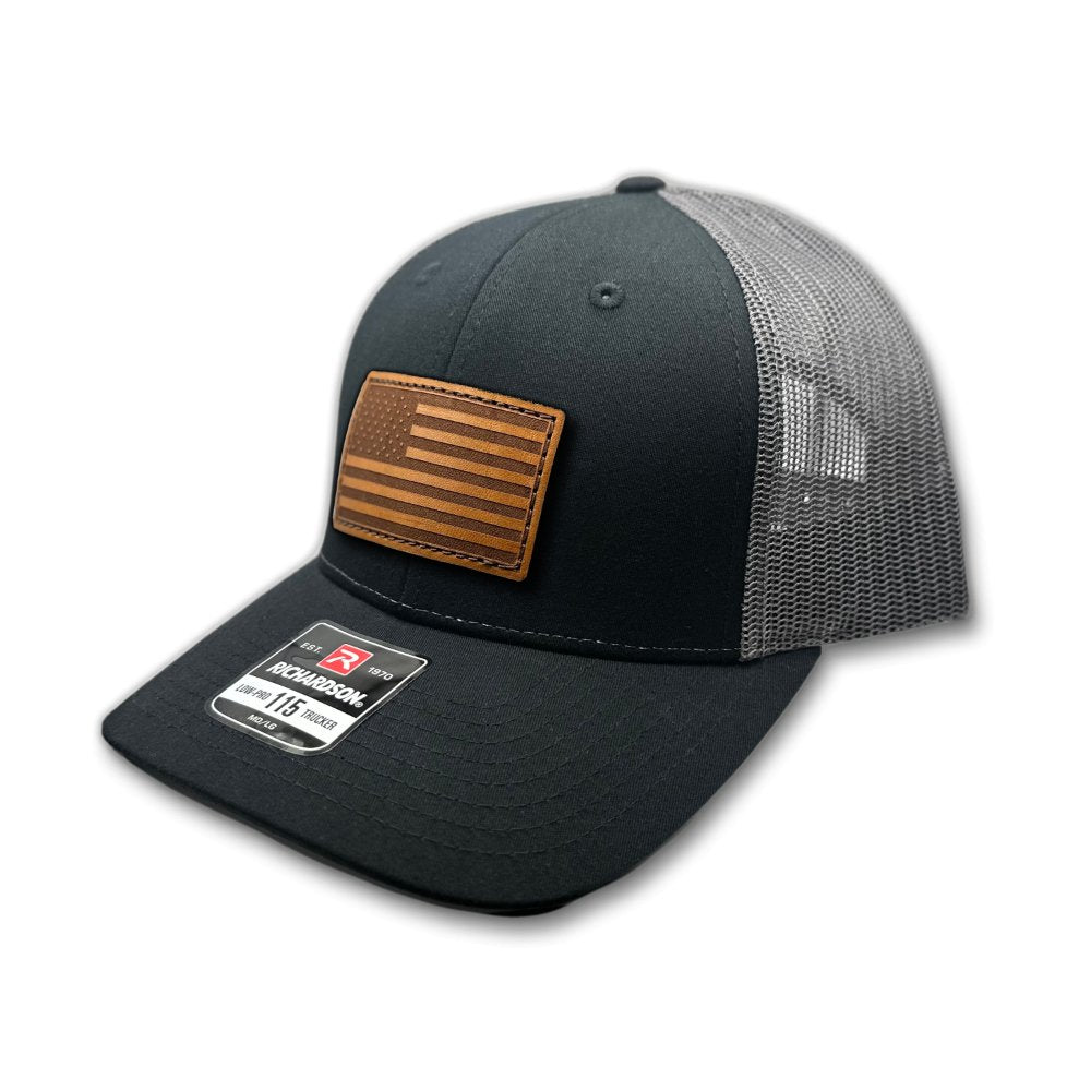 Side view of the Black/Charcoal American Flag Hat, highlighting the charcoal mesh back and snapback closure, with the American Flag leather patch visible from the side.