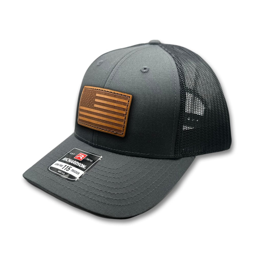 Side view of the Charcoal/Black American Flag Hat, displaying the charcoal mesh back and adjustable snapback closure, with the American Flag leather patch visible from the side.