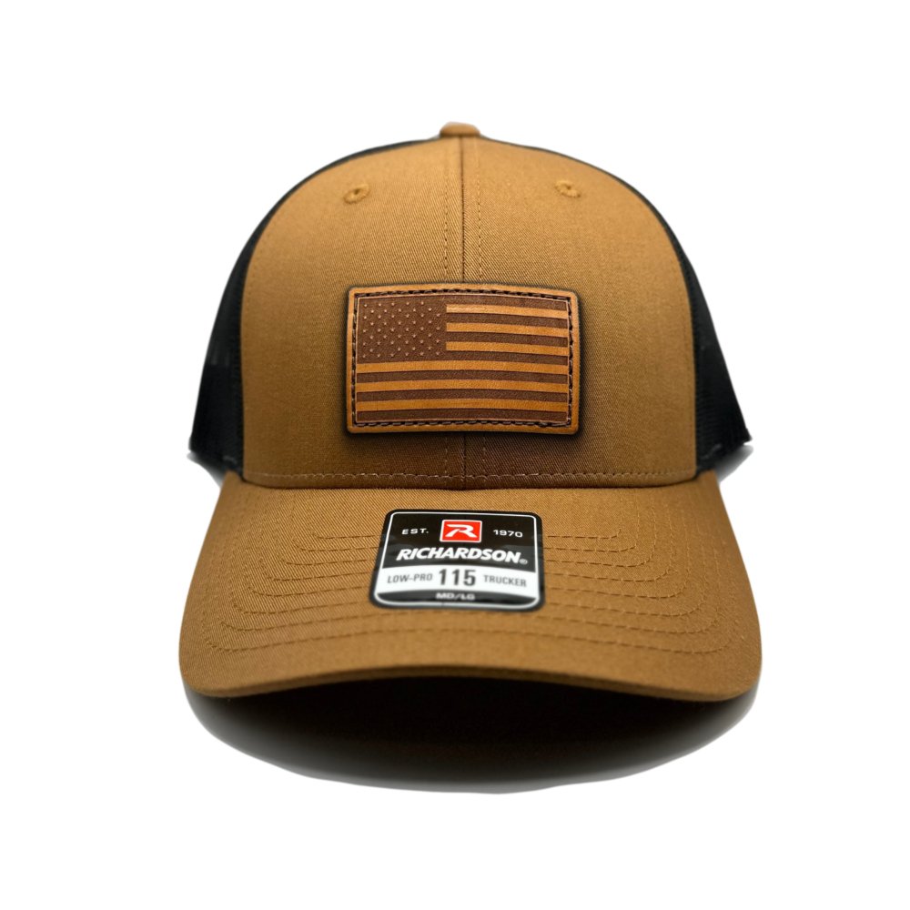 Caramel/Black American Flag Hat by Richardson 115 featuring the genuine leather American Flag patch, laser-engraved and hand-sewn, on a caramel and black trucker hat.