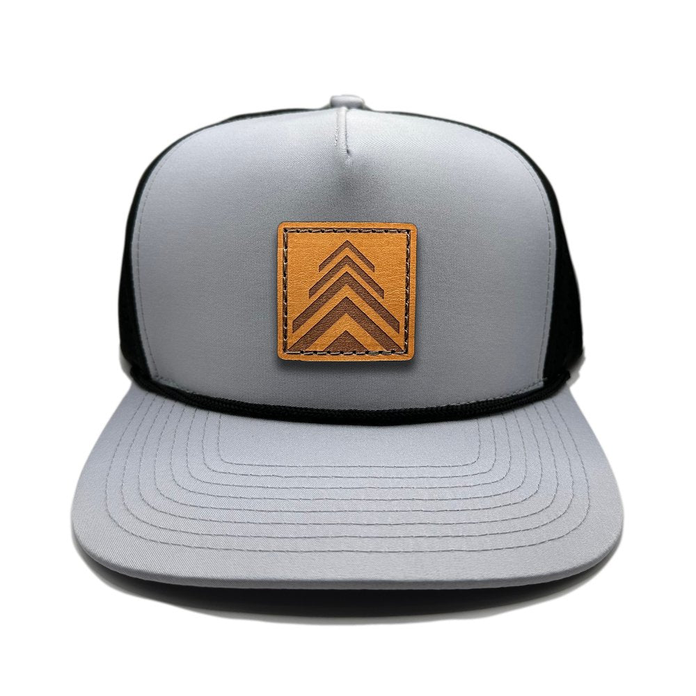 Front view of the Arrow Pine Hat by Outer Wings in grey/black, featuring a high-profile Outer Wings 970 hat with a unique square patch of a triple arrow design resembling a pine tree. The grey front with black mesh back adds contrast, making it a versatile choice for any outdoor adventure.