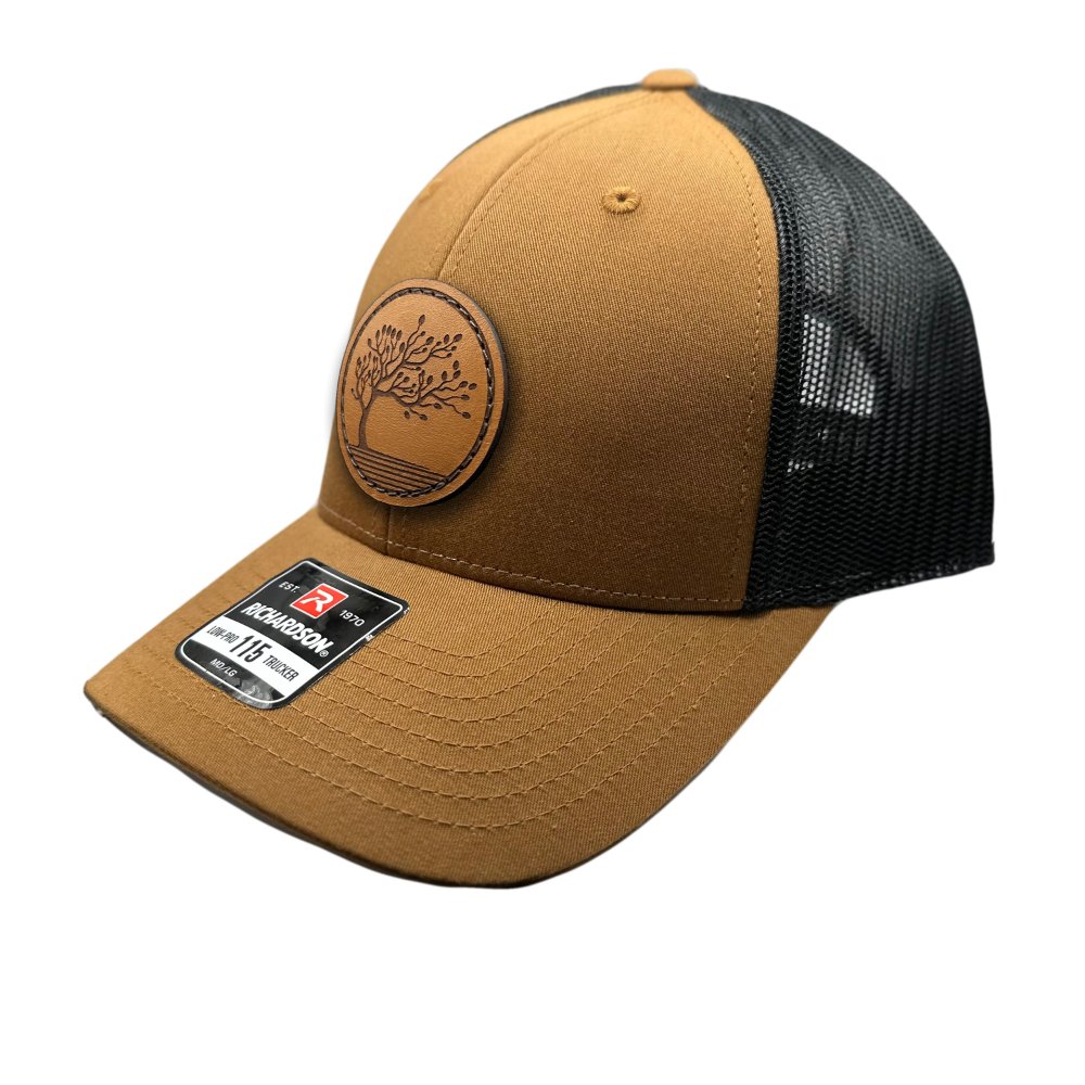 Side view of the Blossom Leather Patch Hat by Outer Wings in caramel/black, highlighting the hat’s low-profile fit, adjustable SnapBack, and the beautifully sewn Blossom leather patch. Ideal for adding a touch of elegance to your everyday look.