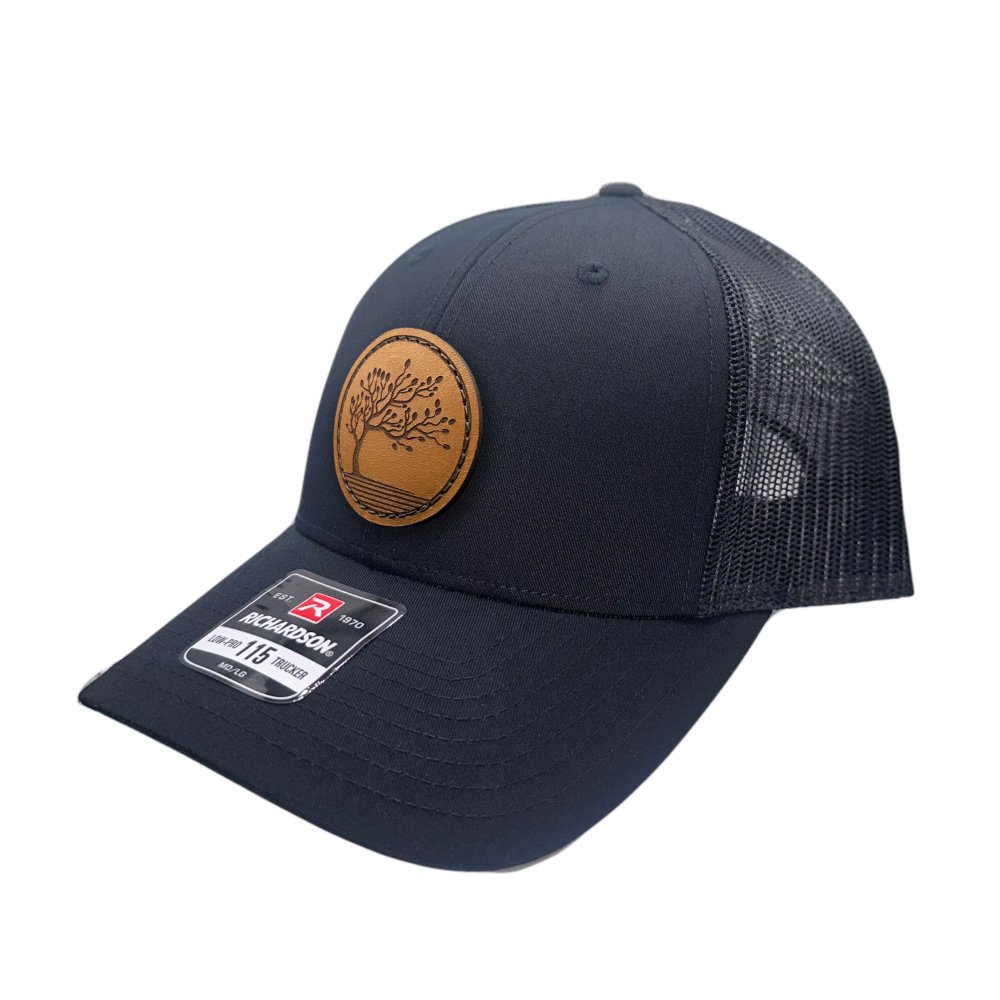 Side view of the Blossom Leather Patch Hat by Outer Wings in black/black, highlighting the hat’s low-profile structure, comfortable fit, and the distinctive Blossom leather patch. The adjustable SnapBack and real leather patch make it a perfect choice for any occasion.