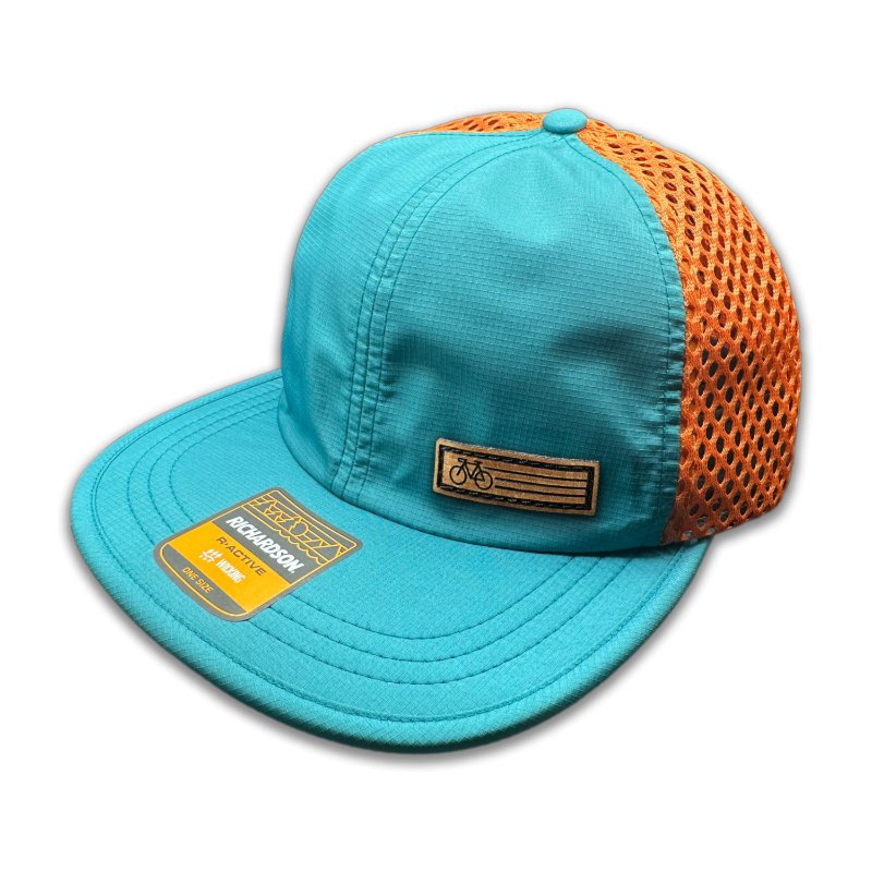 Side view of the Teal Fast Bike Hat, displaying the vibrant orange accents and wide-set mesh back, with the Fast Bike leather patch visible from the side.