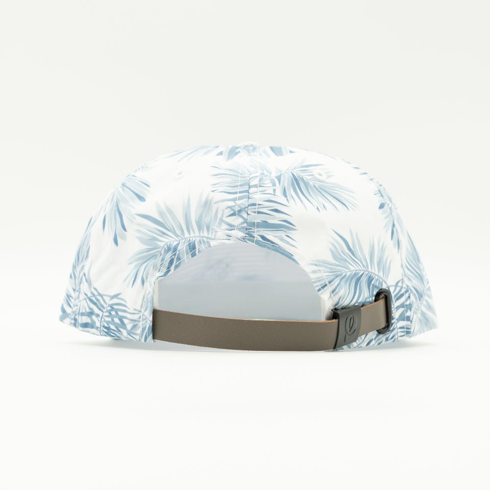 A white baseball cap with a light blue palm leaf pattern, shown from the back with a brown adjustable strap.

Color: Floral Mist