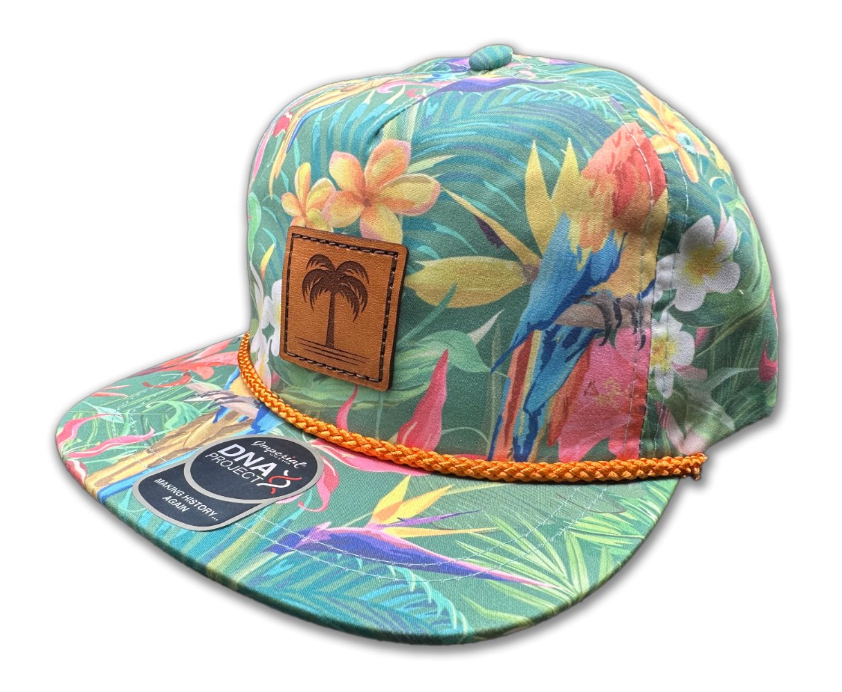 Side view of the Island Breeze Hat in Hawaiian Rainforest, highlighting the unique rainforest-themed print, structured profile, and classic rope detail. The hat includes a genuine leather patch with a palm tree engraving and an adjustable leather strap for a custom fit.