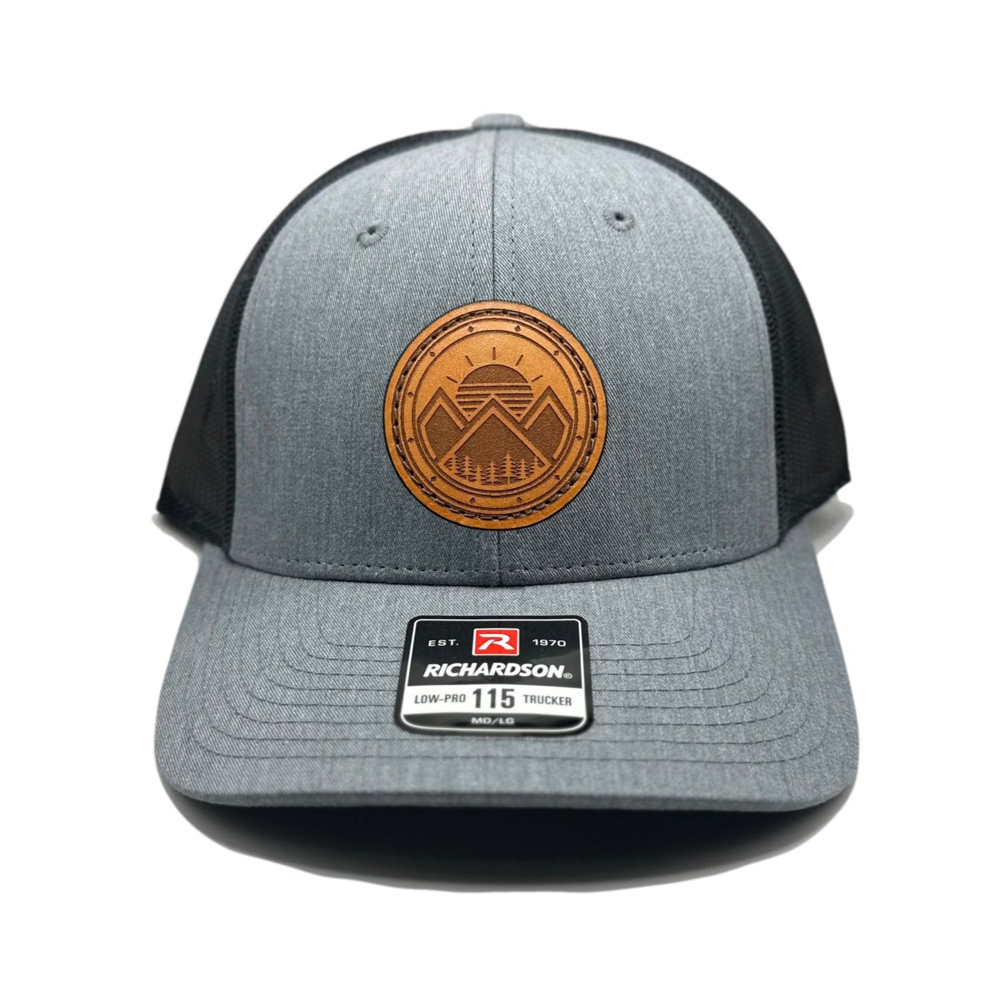 Front view of the Modern Mountains Leather Patch Hat in Heather Grey/Dark Charcoal by Outer Wings, featuring a hand-sewn, genuine leather patch with a modern mountains and sunset design. Built on the Richardson 115 Low Profile Hat, it offers a structured six-panel, low-profile fit with an adjustable SnapBack closure.