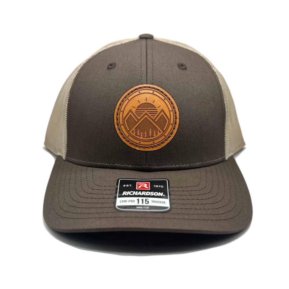 Front view of the Modern Mountains Leather Patch Hat in Brown/Khaki by Outer Wings, featuring a laser-engraved leather patch with a modern mountains and sunset design. Crafted on the Richardson 115 Low Profile Hat, this hat includes a structured six-panel design and an adjustable SnapBack closure for a secure fit.