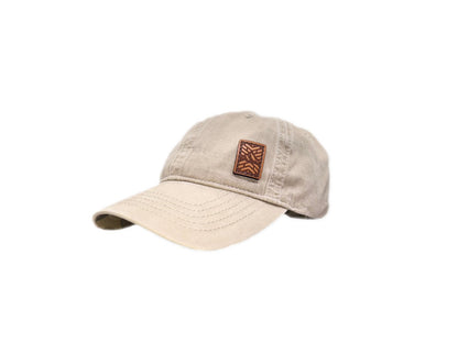 Women's baseball hat with leather patch. Our custom designed leather patch is laser engraved and sewn onto a women's cap. We use full-grain, veg tanned leather. Women's hats have a hidden pony tail opening and makeup resistant band.