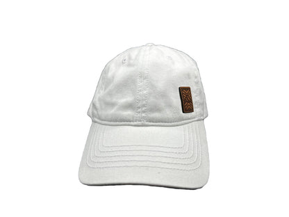 Women's baseball hat with leather patch. Our custom designed leather patch is laser engraved and sewn onto a women's cap. We use full-grain, veg tanned leather. Women's hats have a hidden pony tail opening and makeup resistant band.