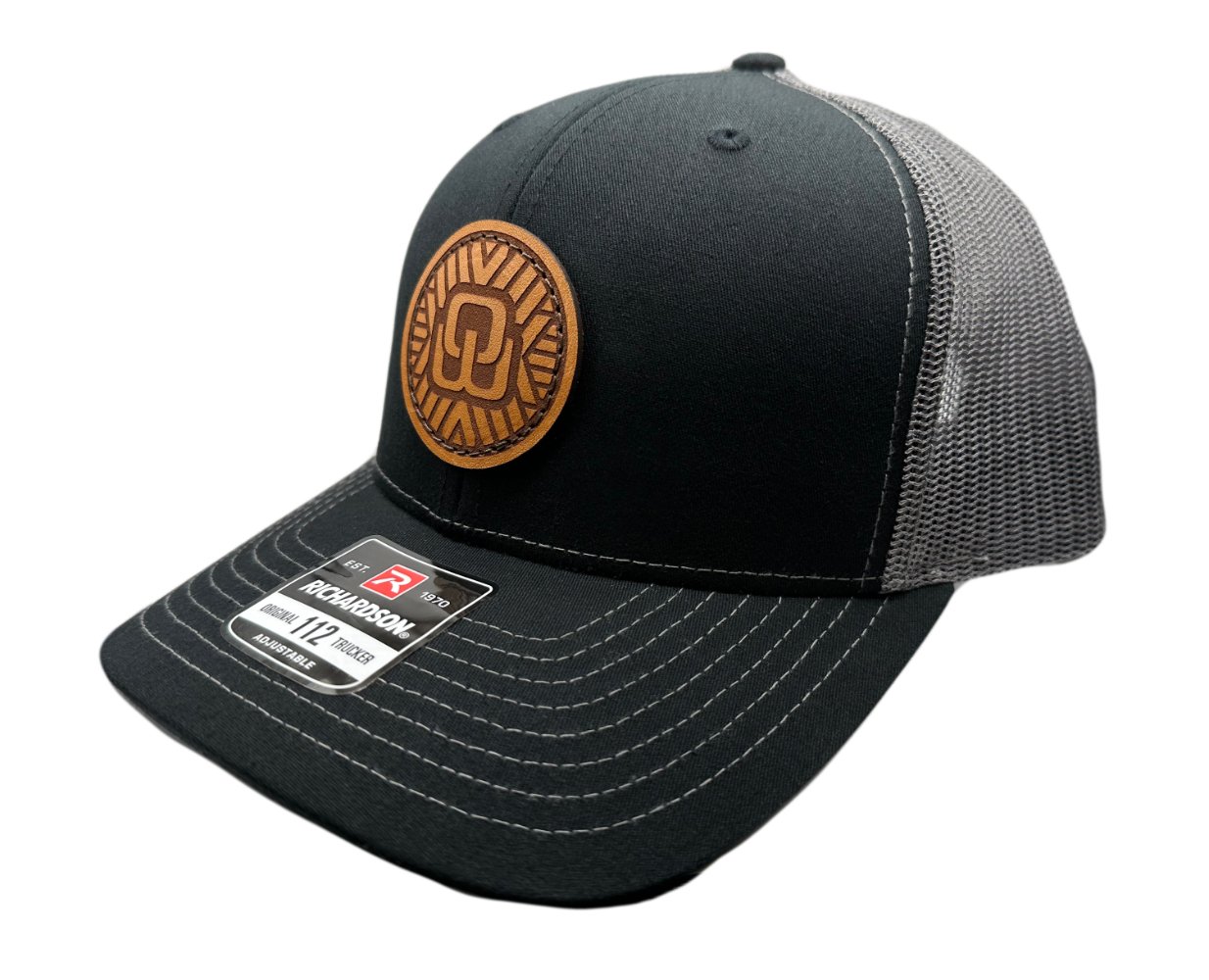 Side view of the Mosaic Wings Leather Patch Hat by Outer Wings in black/charcoal, showing the mid-profile structure of the Richardson 112 hat. The side view emphasizes the detailed leather patch with the Mosaic Wings engraving, making this hat a standout piece among custom leather patch hats. Perfect for outdoor adventures, the breathable mesh back and adjustable SnapBack offer comfort and style.