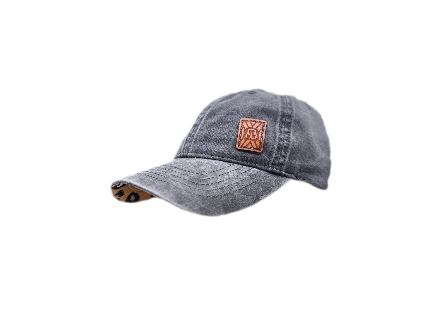 Women's baseball hat with leather patch. Our custom designed leather patch is laser engraved and sewn onto a women's cap. We use full-grain, veg tanned leather. Women's hats have a hidden pony tail opening and makeup resistant band.