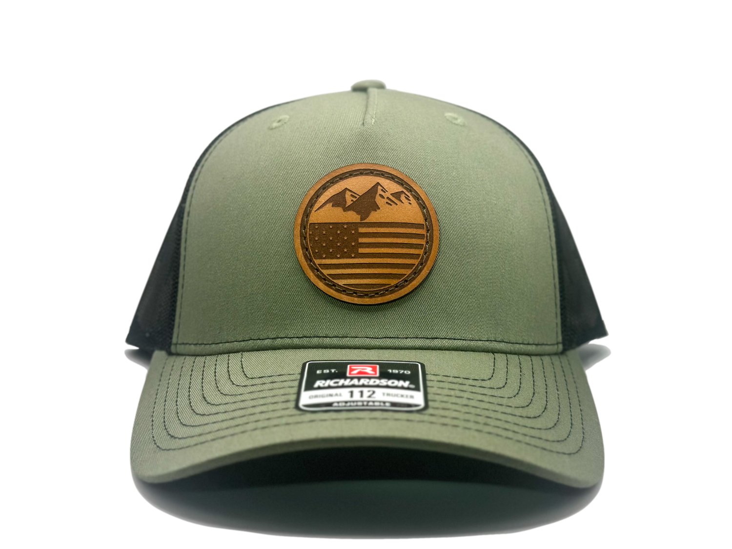 Front view of the Mountain Flag leather patch hat on Richardson 112FP in Loden/Black, featuring a five-panel, mid-profile design with a leather patch combining mountains and the American flag. Perfect for those seeking high-quality Colorado hats.