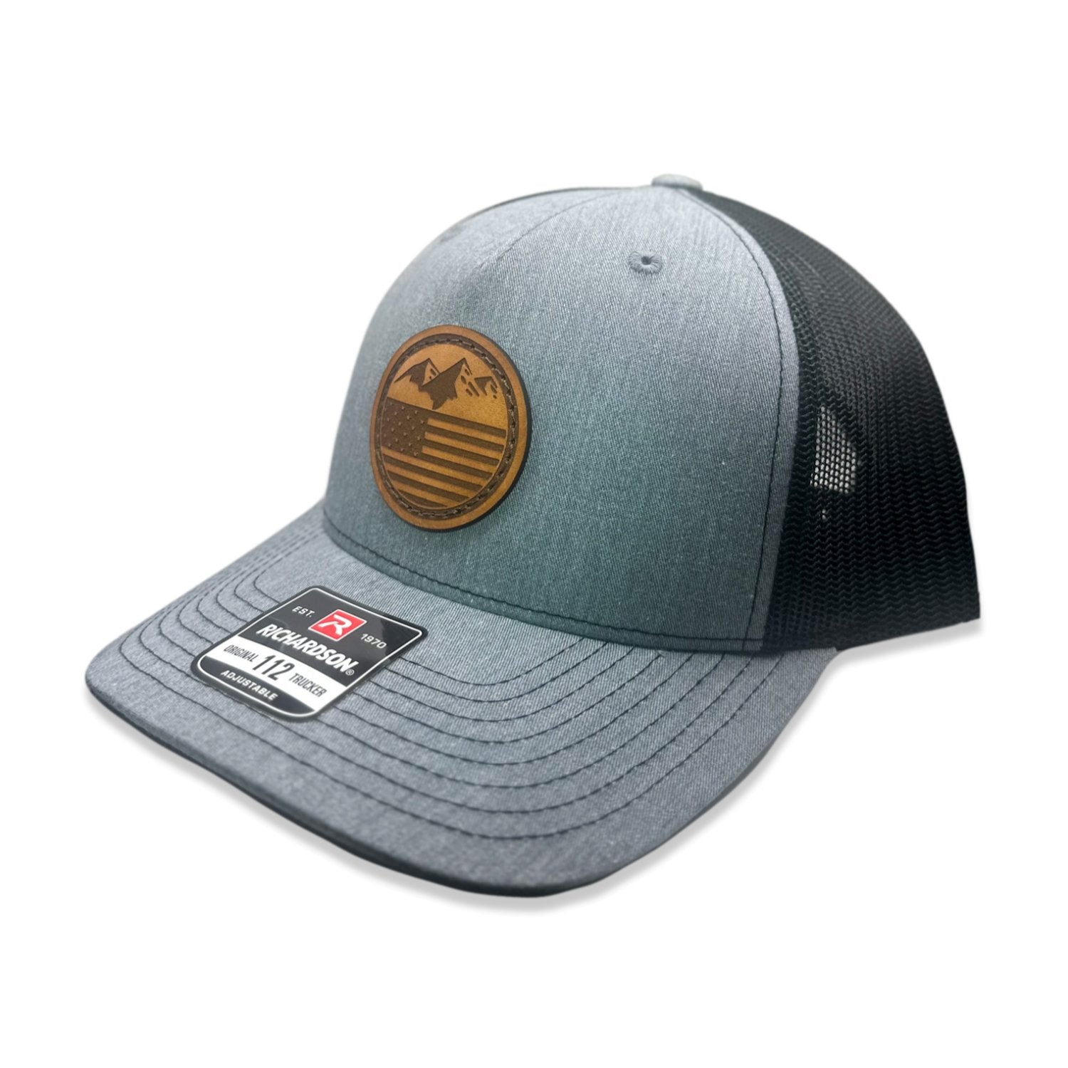 Side view of the Mountain Flag leather patch hat on Richardson 112FP in Heather/Black, highlighting the flat bill, adjustable snapback, and seamless front panel. The perfect custom leather patch hat for outdoor activities.