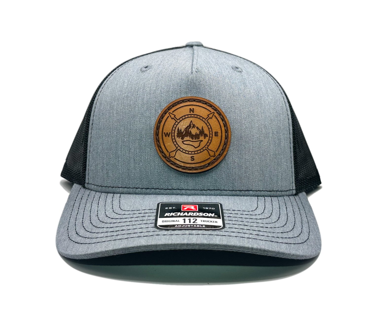 Front view of the Outdoor Compass Leather Patch Hat by Outer Wings in Heather/Black, featuring a mid-profile, five-panel Richardson 112FP hat with a round leather patch showcasing an Outdoor Compass design. Ideal for outdoor enthusiasts and hikers.