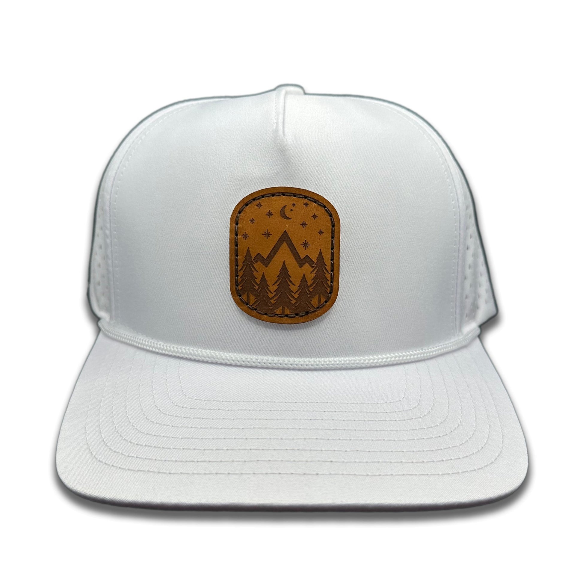 Front view of the Starry Night Leather Patch Hat by Outer Wings in White, featuring a high-profile, five-panel Outer Wings 970 rope trucker hat with a laser-engraved leather patch showing mountains, pine trees, stars, and a half moon. Perfect for outdoor enthusiasts.