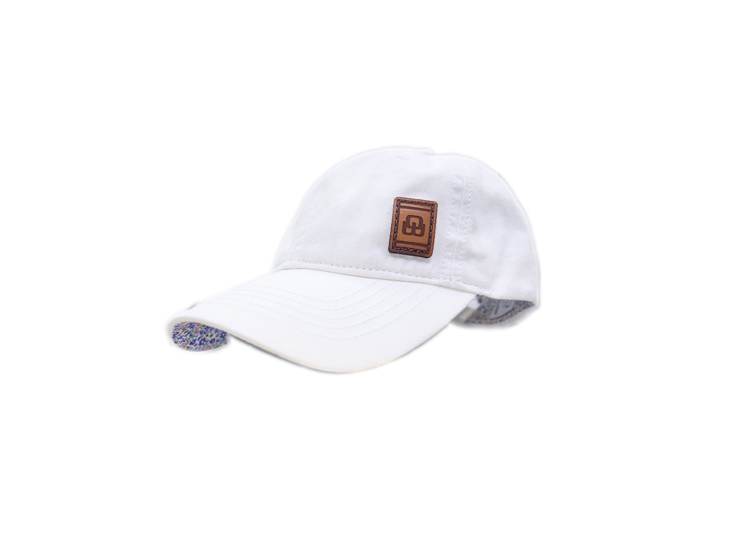 Women's baseball hat with leather patch. Our custom designed leather patch is laser engraved and sewn onto a women's cap. We use full-grain, veg tanned leather. Women's hats have a hidden pony tail opening and makeup resistant band.