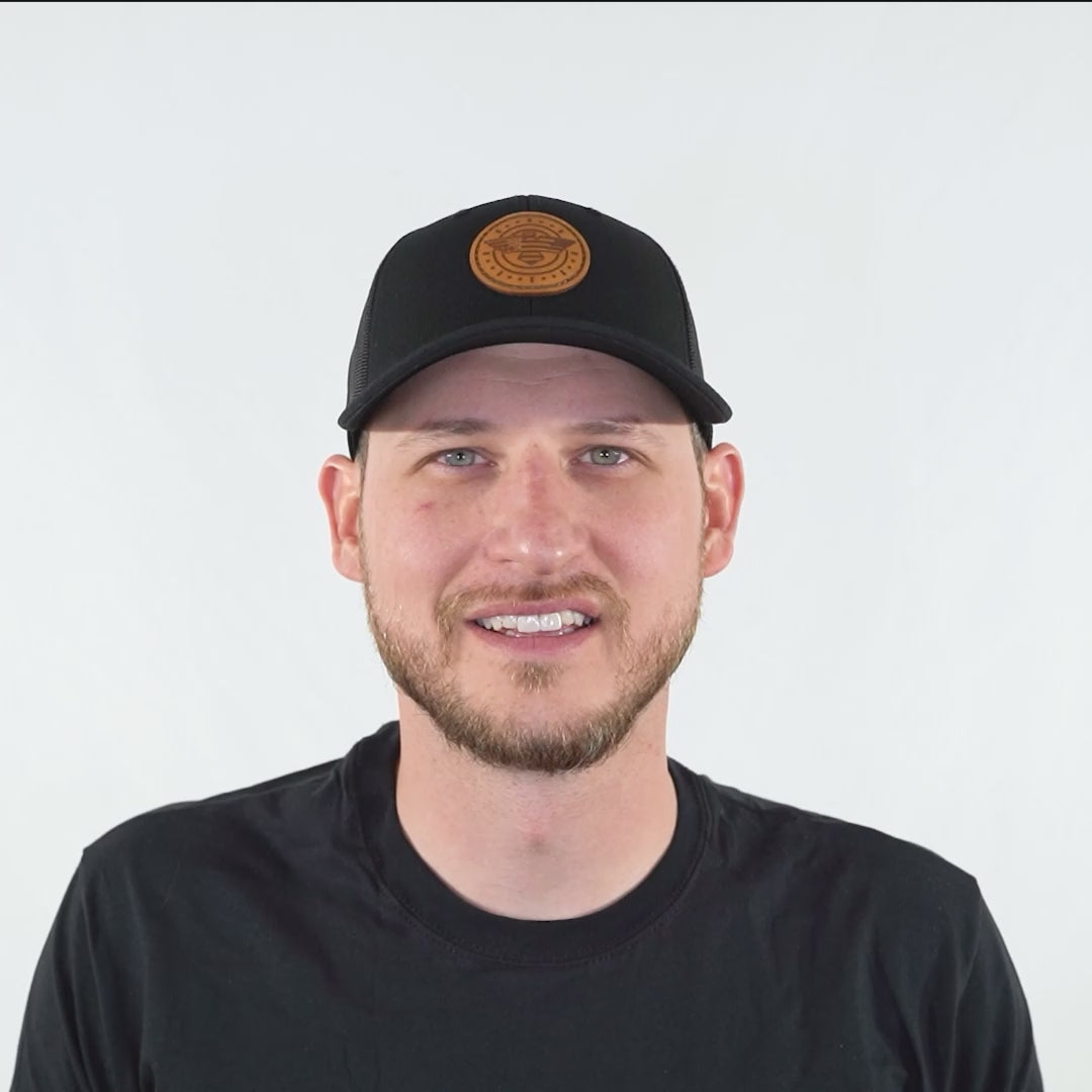 Video of model wearing solid black Richardson 115 low profile American Eagle leather patch hat, turning head side to side to show the engraved eagle and flag patch and mesh snapback.
Color: Solid Black