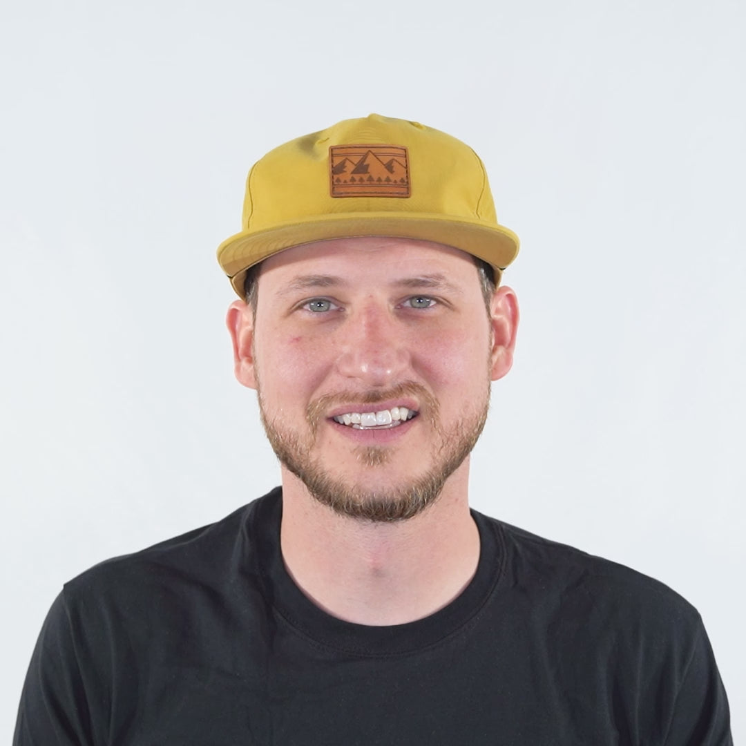 Video of model wearing biscuit Richardson 256 Ridgeline rope hat, turning head side to side to show the leather patch, shallow fit, and snapback closure.
Color: Biscuit