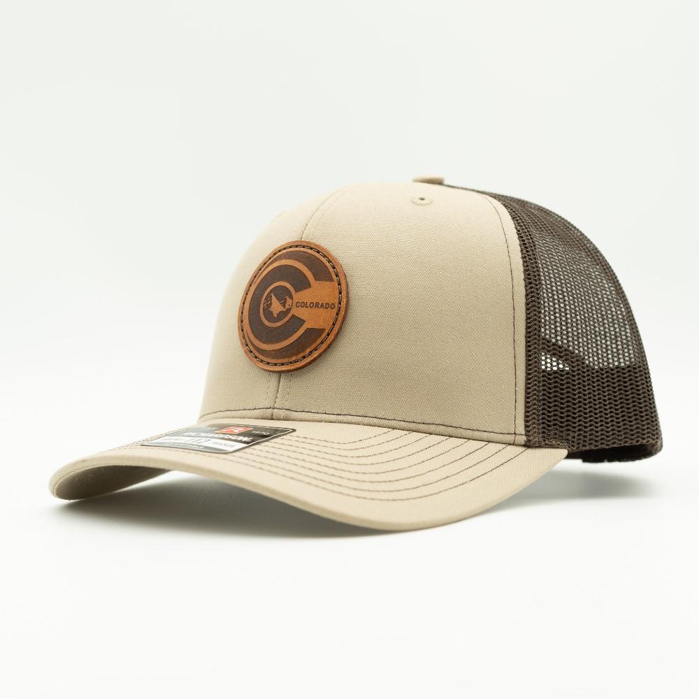 Side view of khaki and brown Richardson 112 trucker hat with round Colorado flag leather patch, brown mesh back and curved visor.

Color: Khaki/Coffee