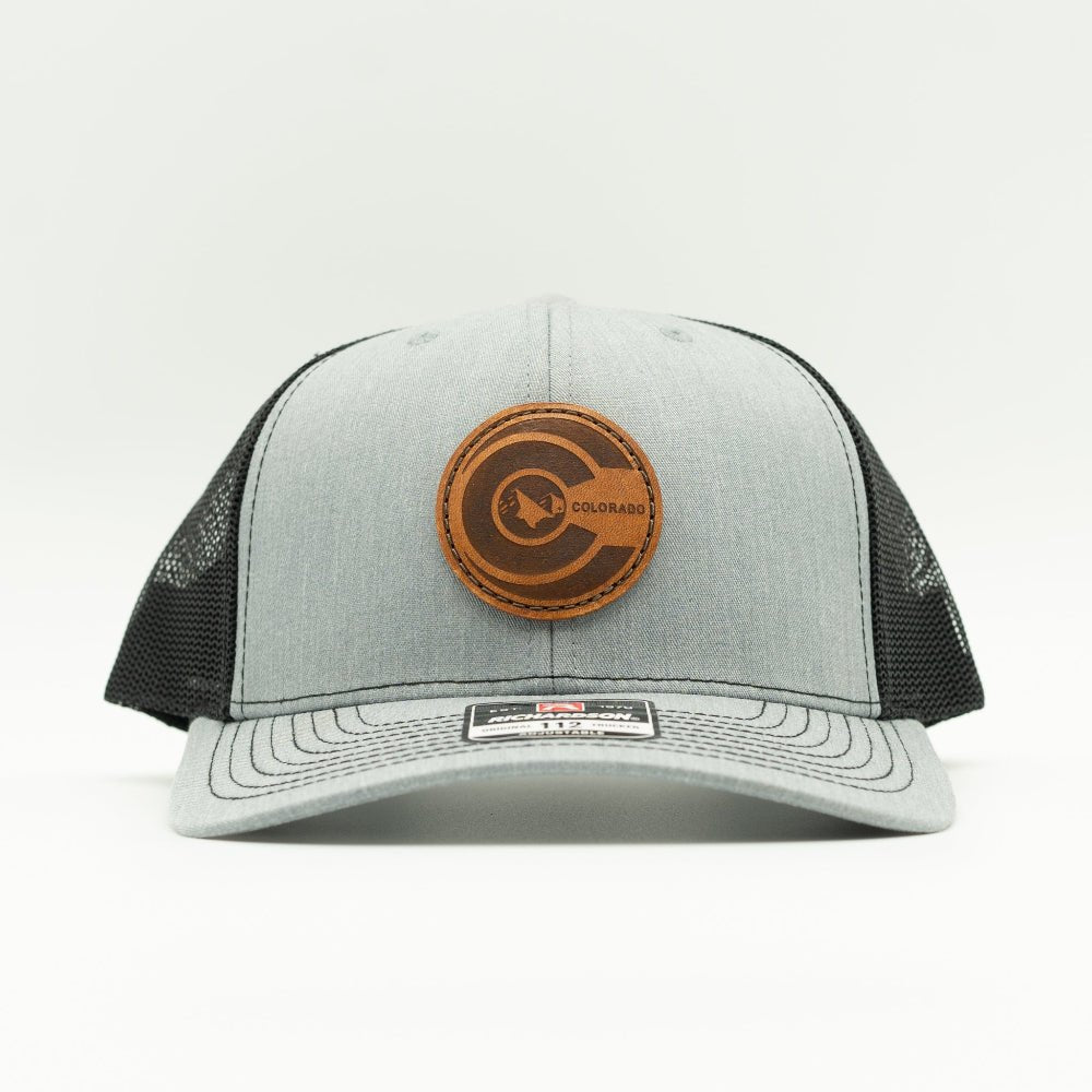 Front view of heather grey and black Richardson 112 mid-profile trucker hat with round engraved leather Colorado flag patch.

Color: Heather Grey/Black