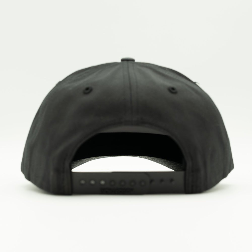 Back view of charcoal/black Richardson 312 hat showing adjustable snapback closure and full-fabric mid profile crown.