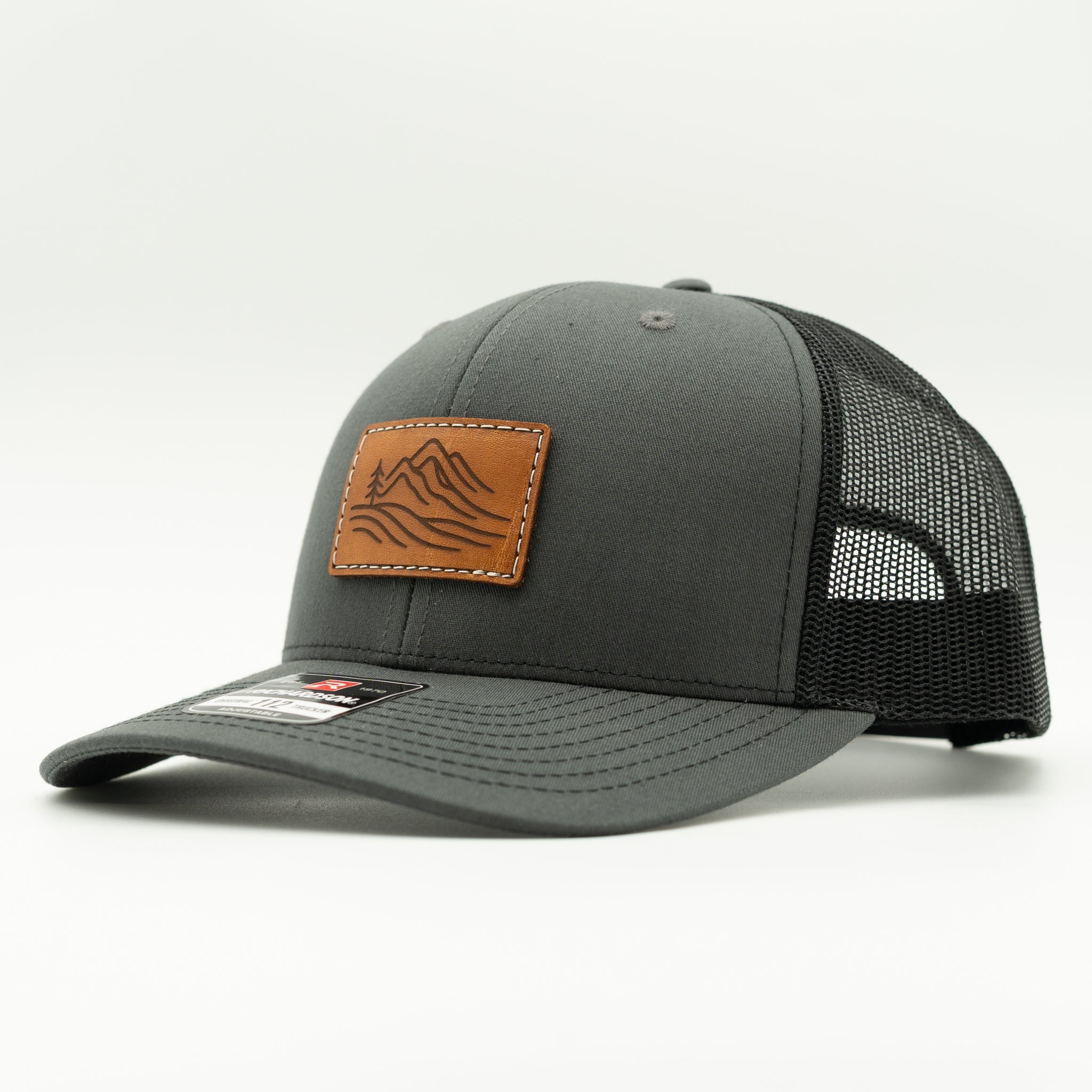 Side view of charcoal and black Richardson 112 Driftline leather patch hat, everyday mountain trucker with mesh back

Color: Charcoal/Black