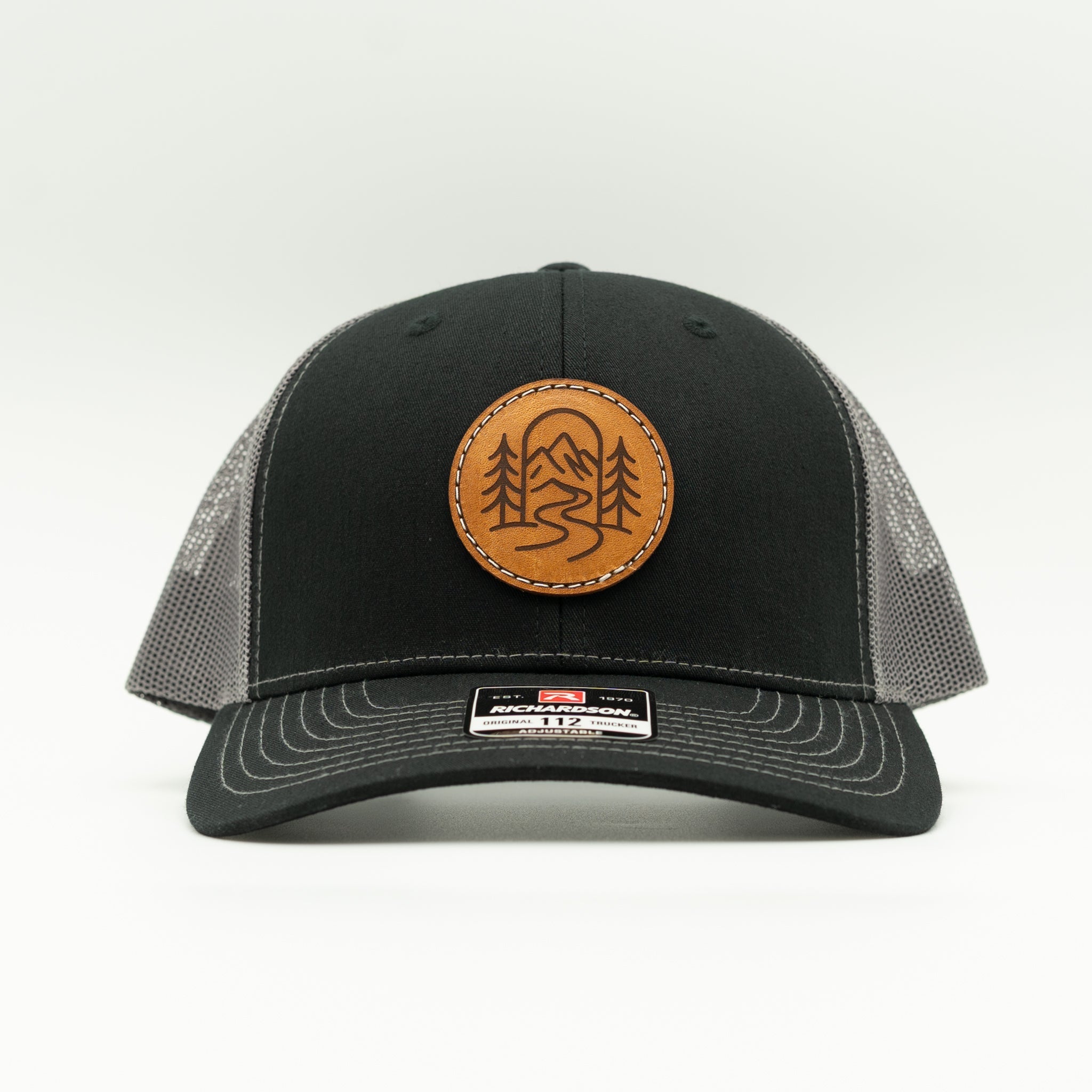 Front view of black and charcoal Richardson 112 The Passage hat with round mountain leather patch.