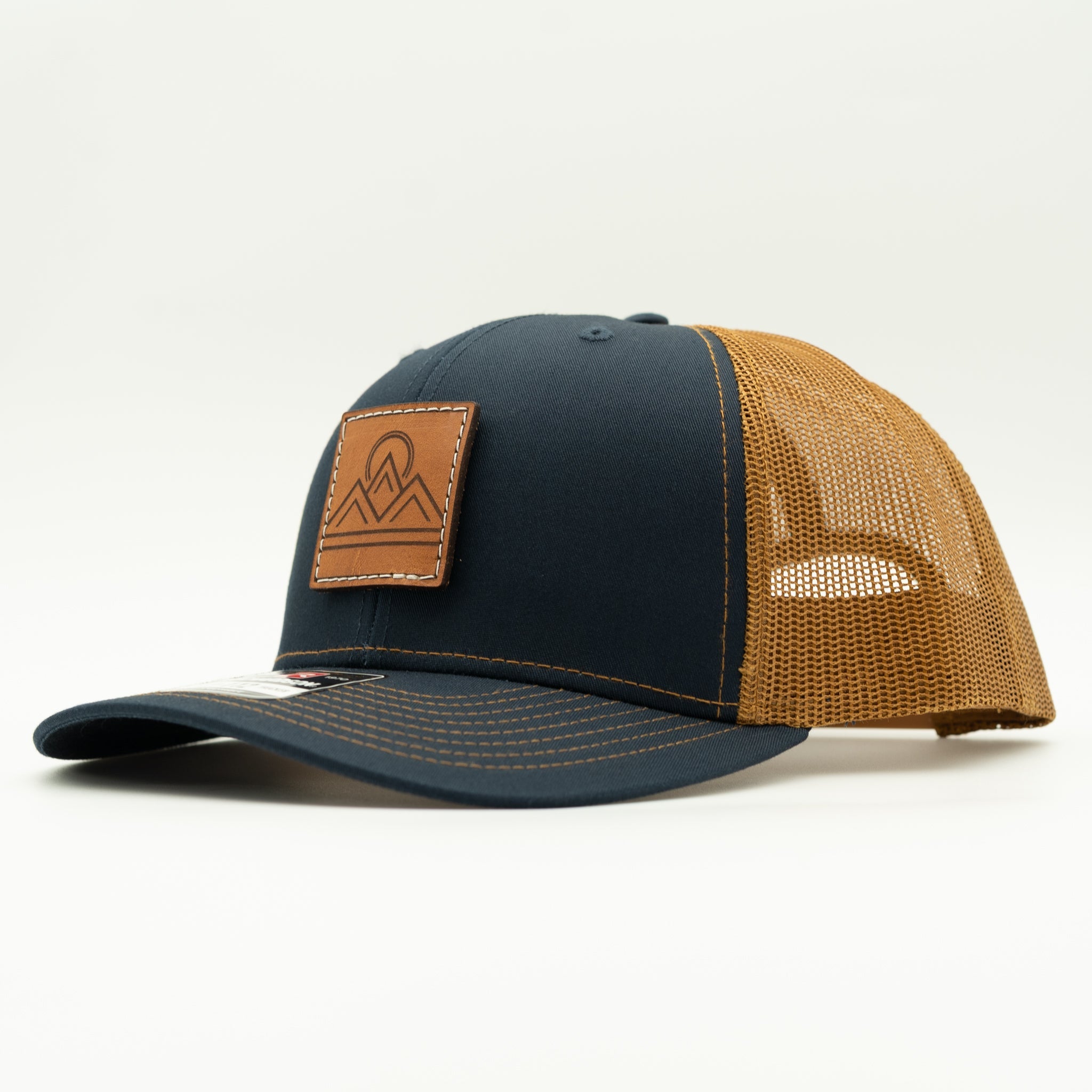 Side view of Lunar Ridge navy and caramel Richardson 112 leather patch mountain hat with caramel mesh

Color: Navy/Caramel