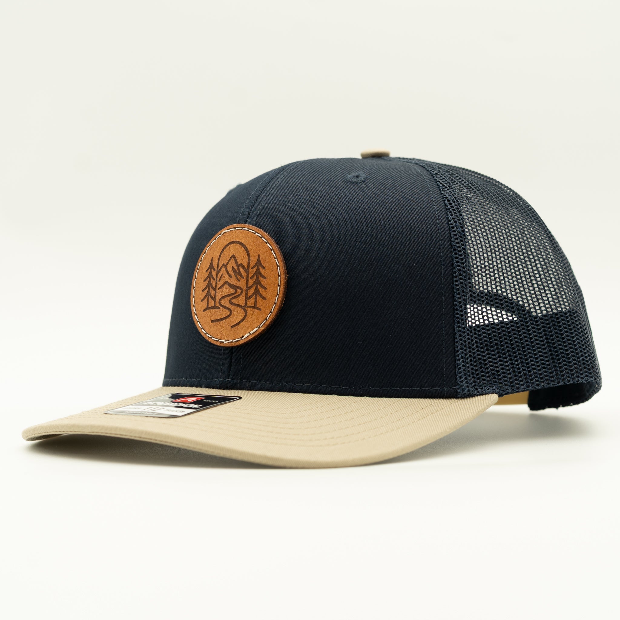 Side view of The Passage navy and khaki Richardson 112 leather patch mountain hat.