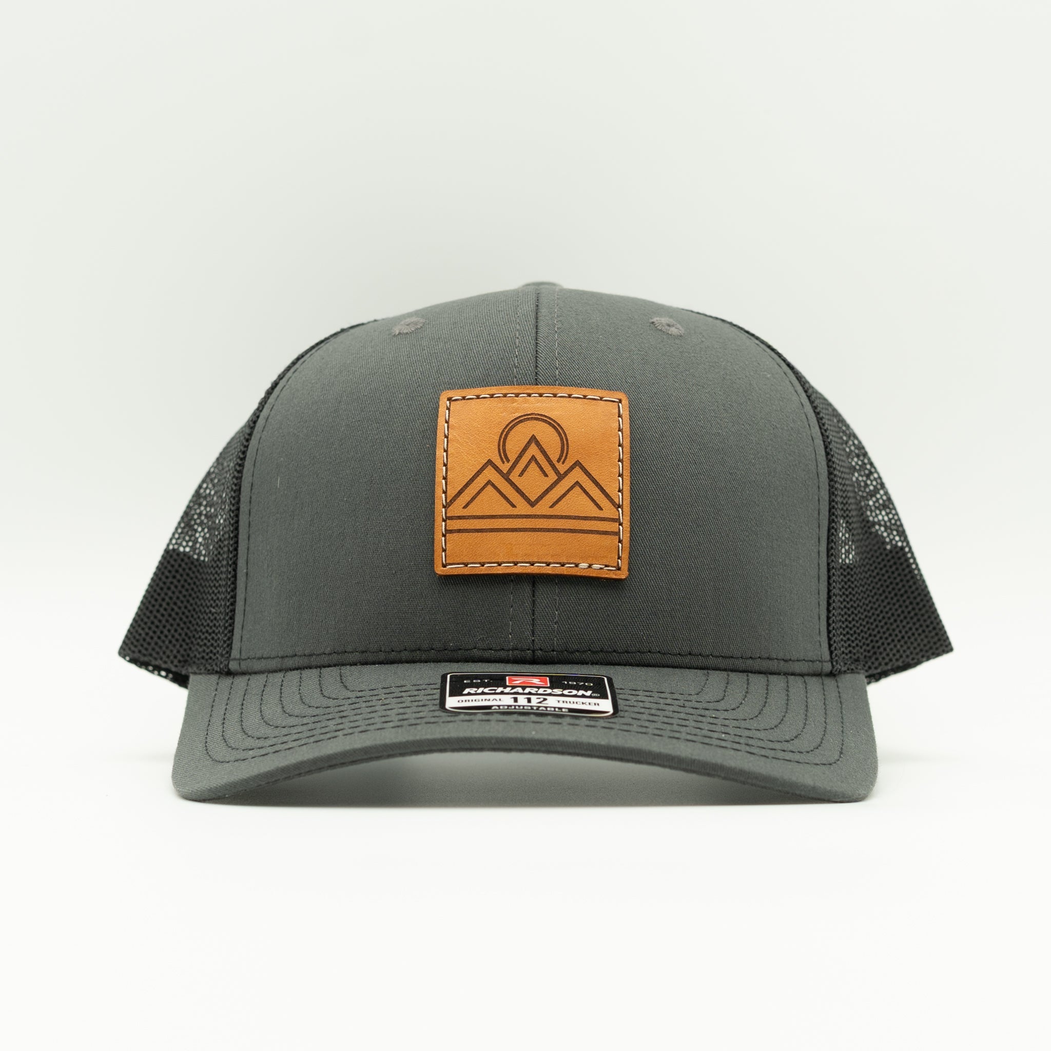 Front view of Lunar Ridge charcoal and black Richardson 112 trucker hat with square veg tan mountain patch

Color: Charcoal/Black