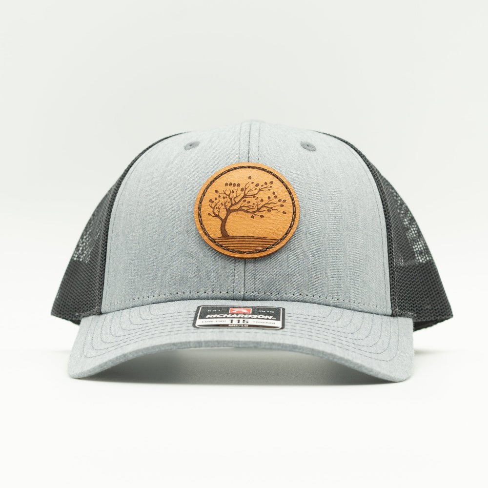 Front view of Heather Grey Charcoal Blossom leather patch hat, Richardson 115 low profile trucker with curved bill.

Color: Heather Grey/Charcoal