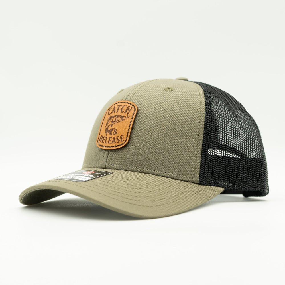 Side view of olive and black Richardson 115 low profile leather patch fishing hat with Catch & Release design and mesh back.

Color: Loden/Black
