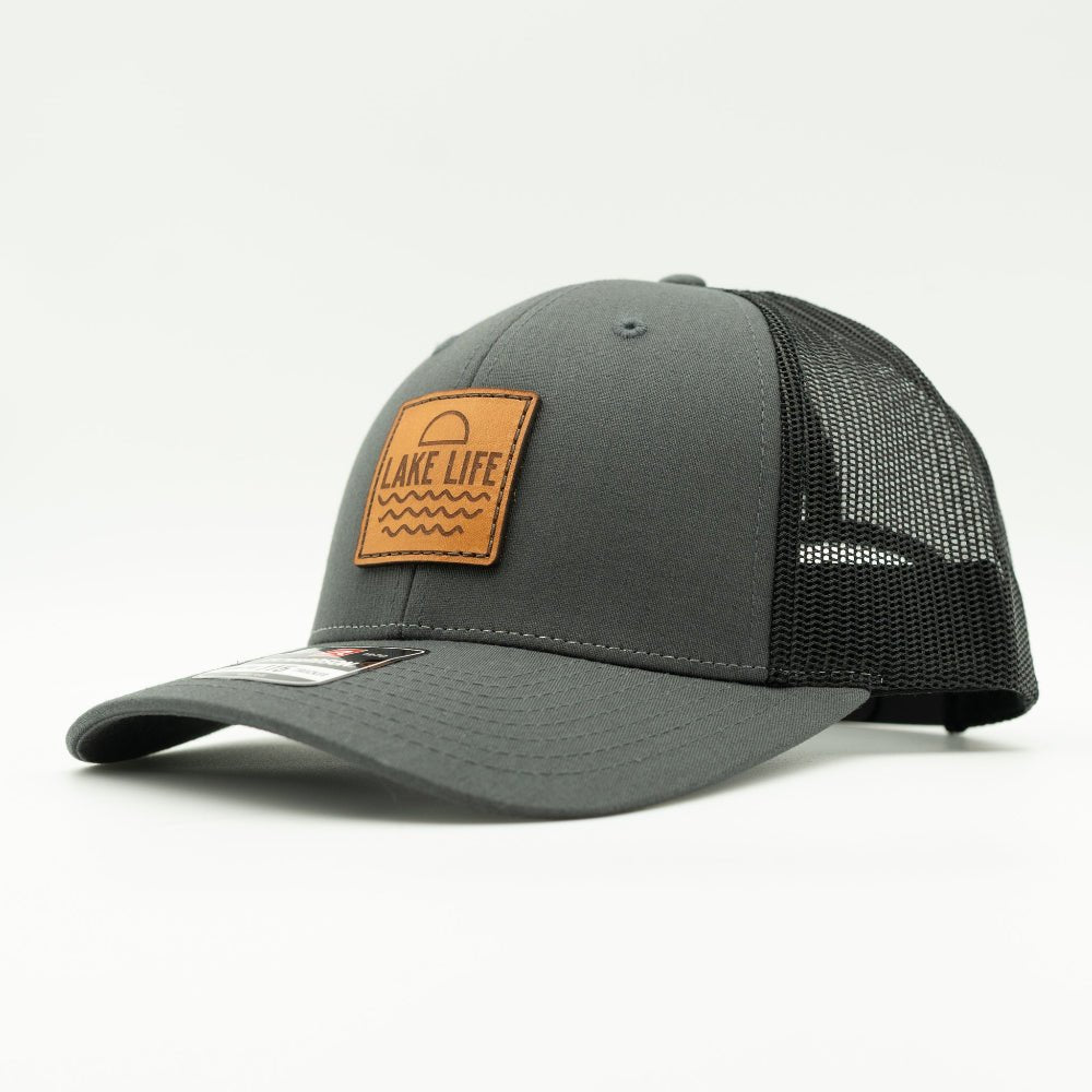 Side view of Lake Life leather patch hat on charcoal and black Richardson 115, highlighting the low profile crown, leather patch, curved bill, and mesh back.

Color: Charcoal/Black