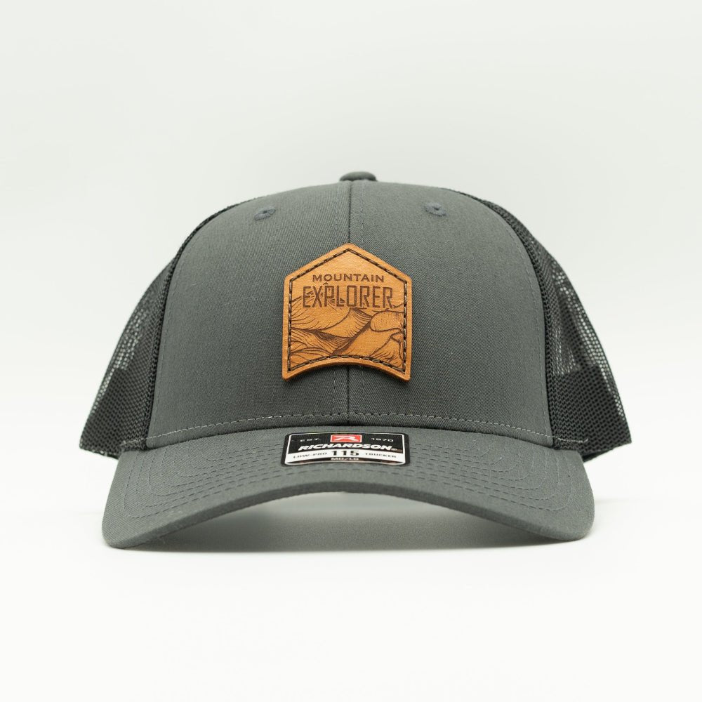 Front view of charcoal and black Mountain Explorer leather patch hat, low profile Richardson 115 mountain trucker with engraved leather patch for trail and town.
