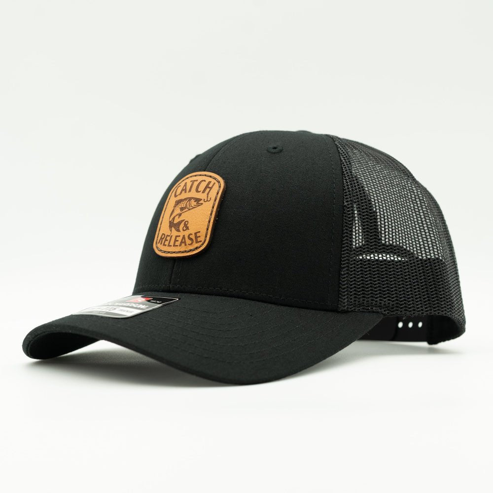 Side view of all black Richardson 115 low profile leather patch hat with Catch & Release design and mesh trucker back.

Color: Solid Black