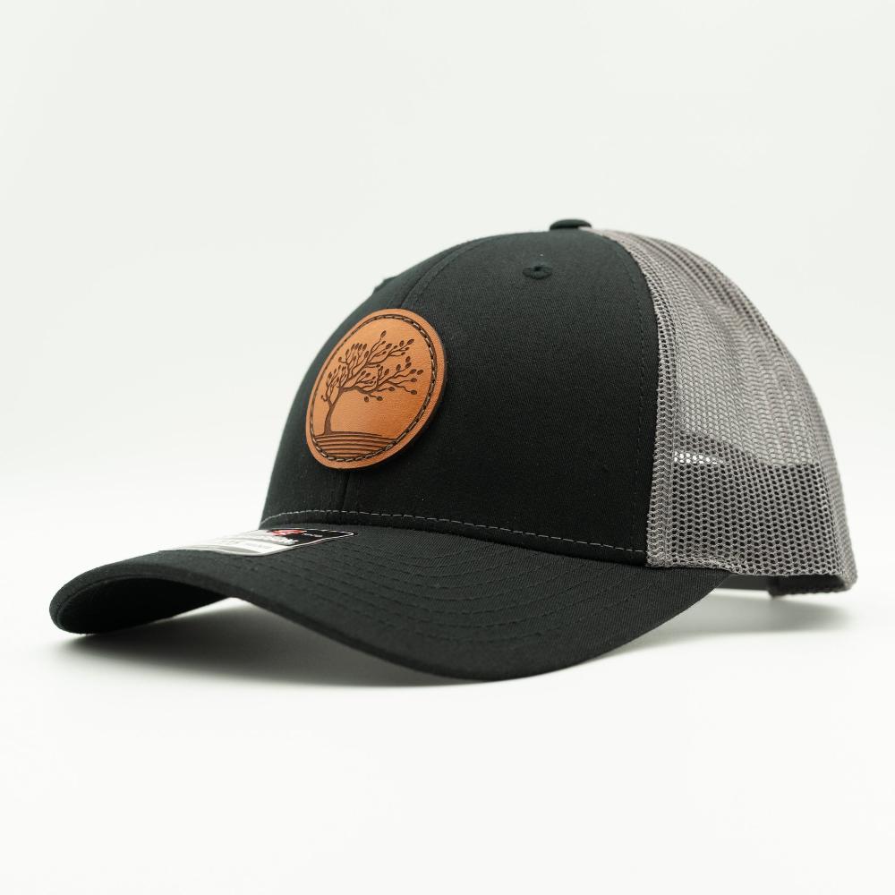 Side angle of Black Charcoal Richardson 115 low profile hat with Blossom leather patch, charcoal front and black mesh back.

Color: Black/Charcoal