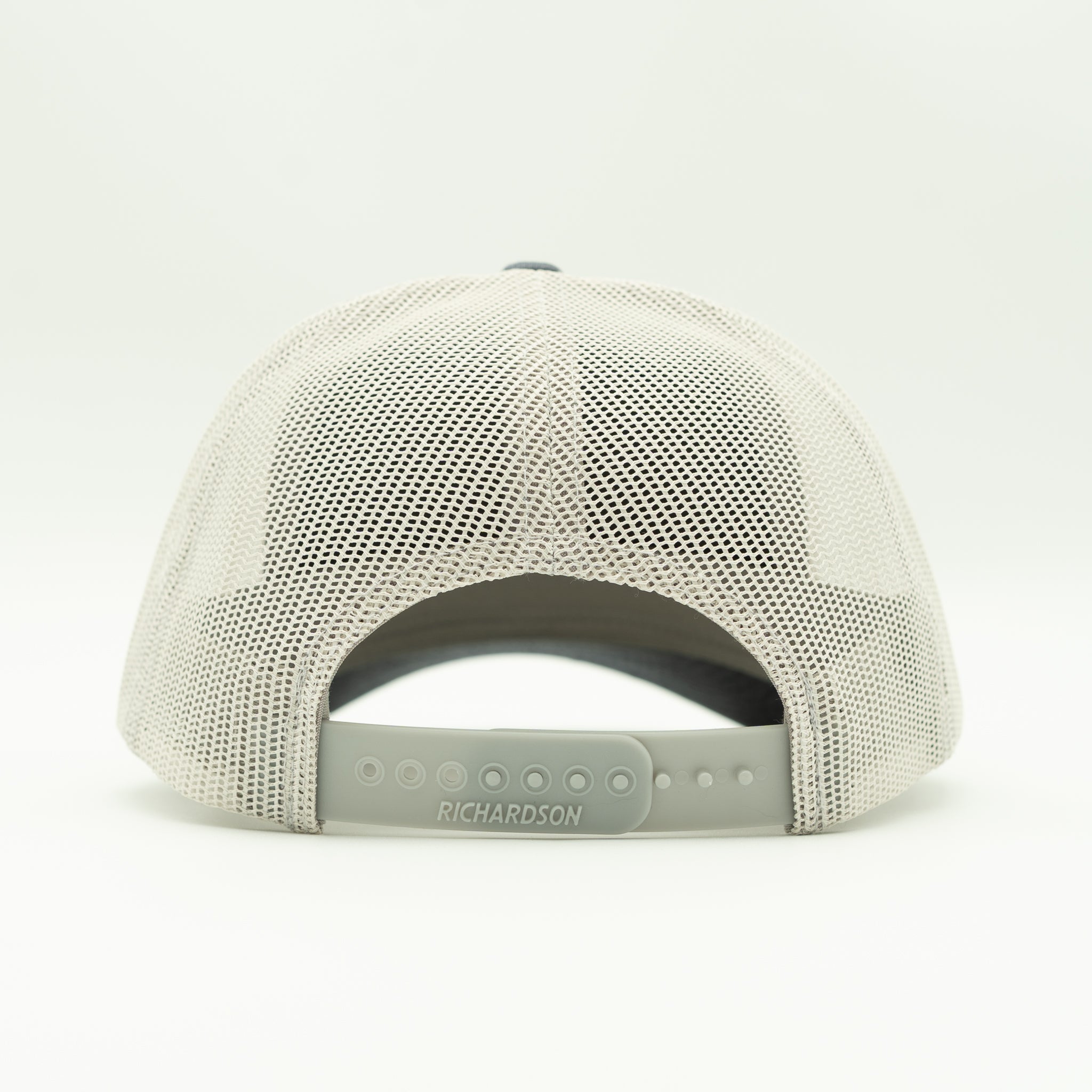 Back angle heather navy/grey Solo Palm cap, grey mesh with snapback strap for adjustable fit on this leather patch trucker.

Color: Heather Navy/Grey