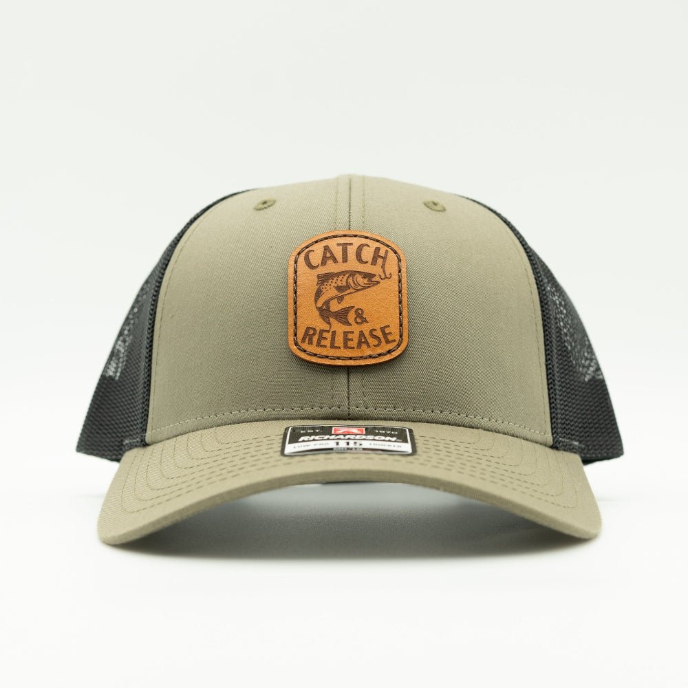 Front view of olive Richardson 115 low profile trucker hat with Catch & Release fish and hook leather patch.

Color: Loden/Black