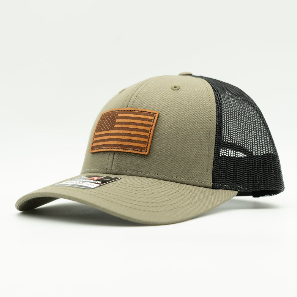 Side view of the Loden/Black American Flag Hat, highlighting the black mesh back and snapback closure, with the American Flag leather patch visible from the side.

Color: Loden/Black