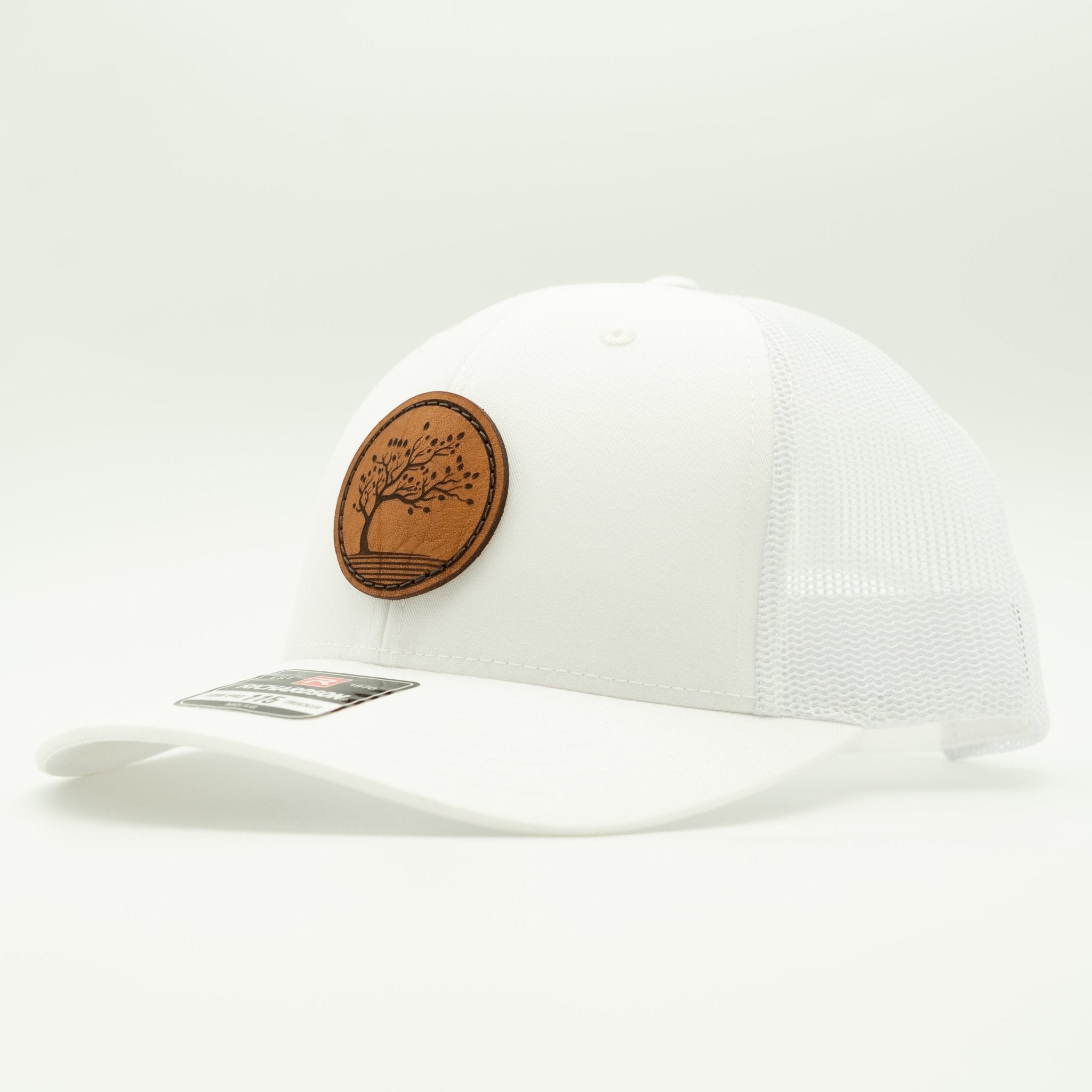 White cap with a brown leather patch featuring a tree design on a white background

Color: Solid White