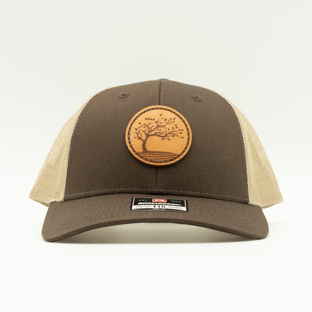 Front view of Brown Khaki Blossom leather patch hat on Richardson 115, low profile mountain town style trucker.

Color: Brown/Khaki